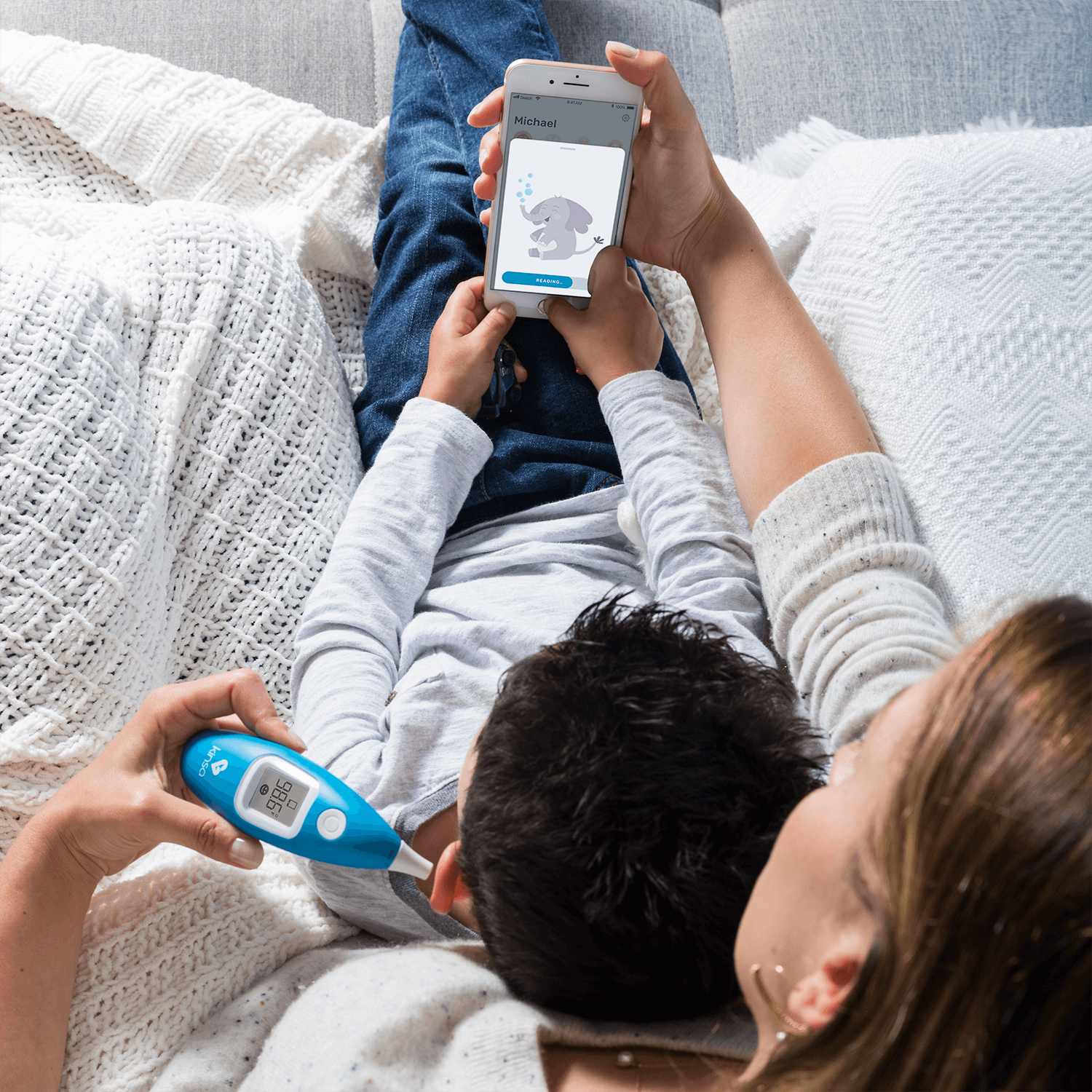 Kinsa Smart Ear Digital Thermometer with App in Use.png