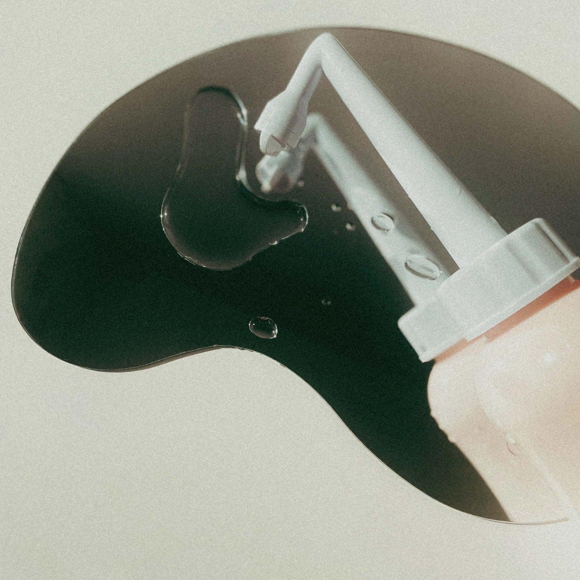 Peri bottle on a mirror with water droplets